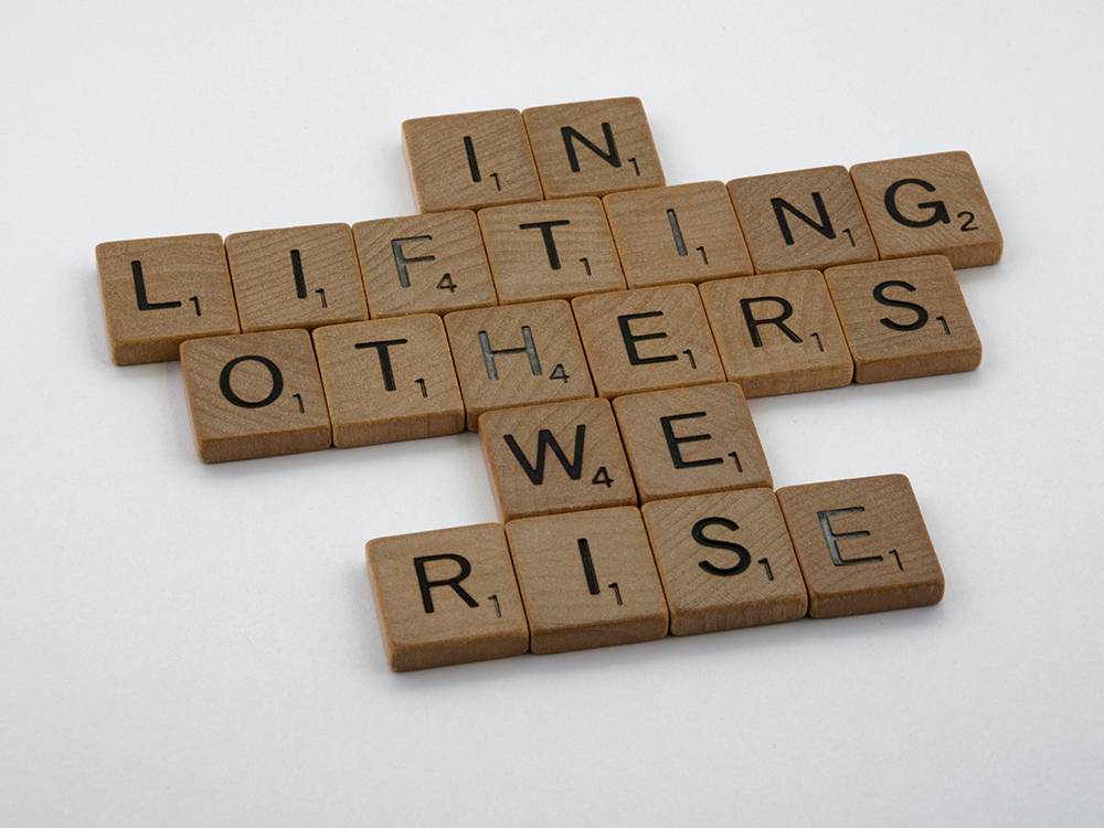 In Lifting Others We Rise